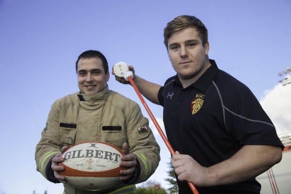 Firefighter and rugby player with a smoke alarm